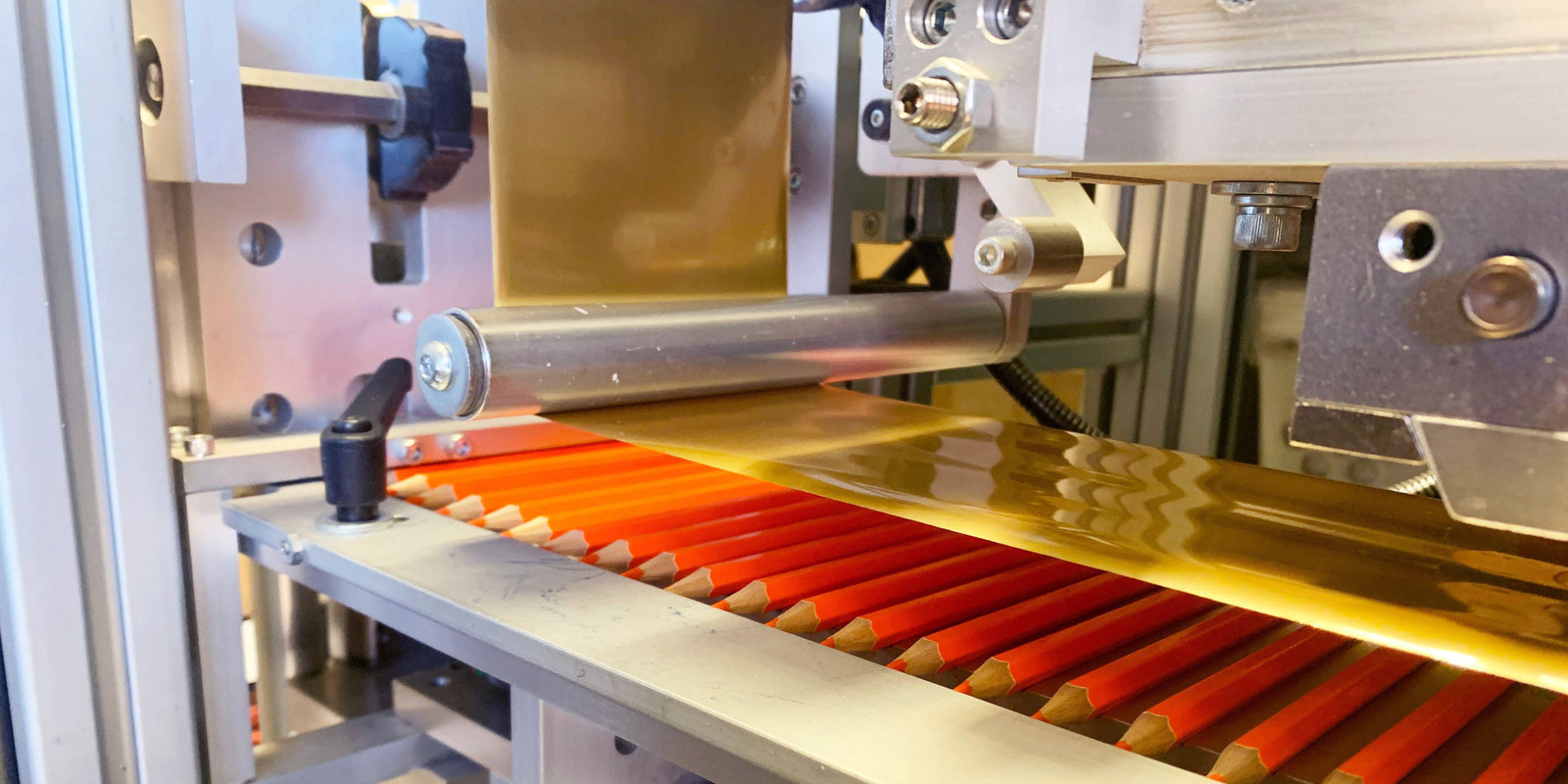 Colored pencils being stamped with custom names